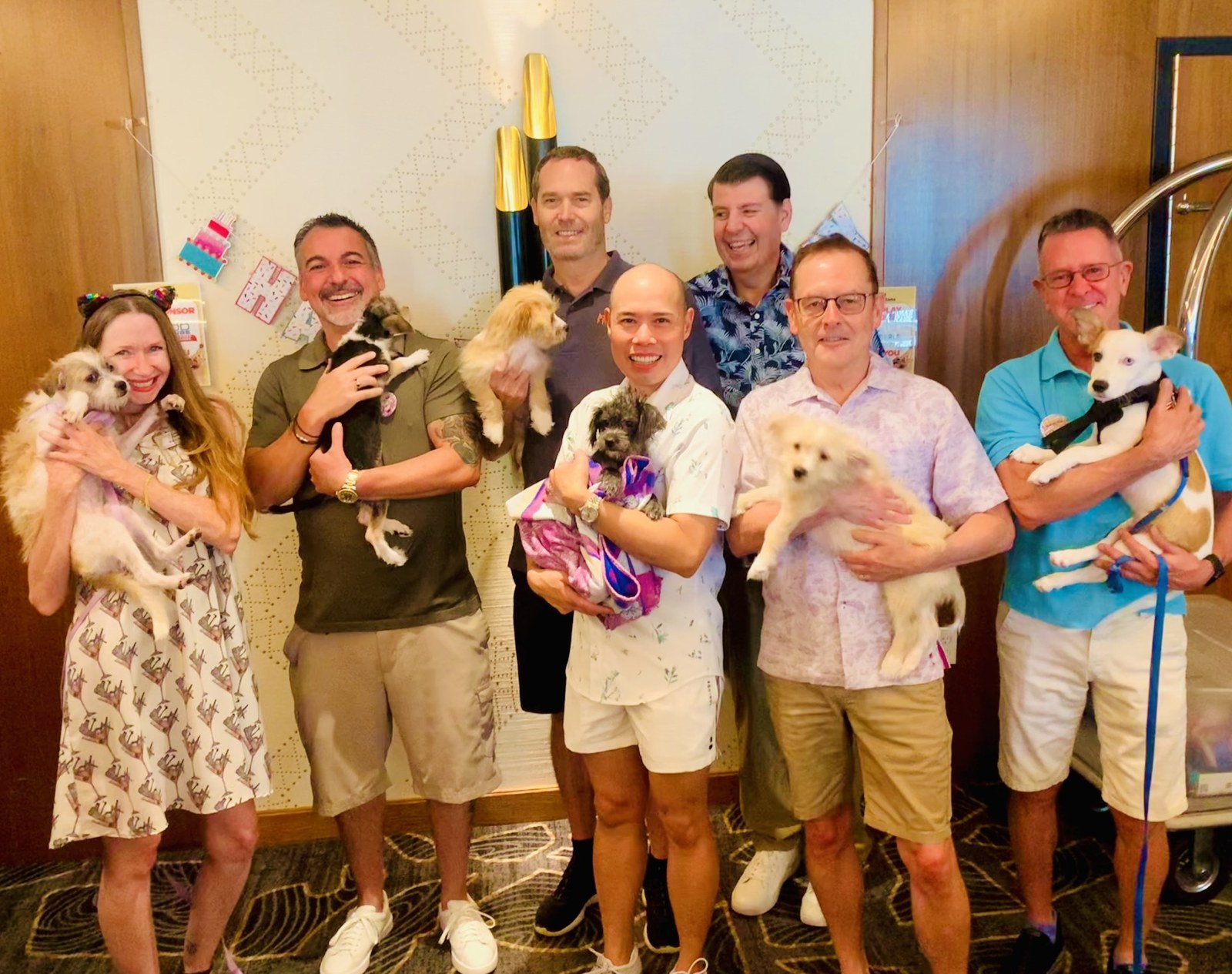 DOGust event attendees holding puppies at the Animal Samaritans event