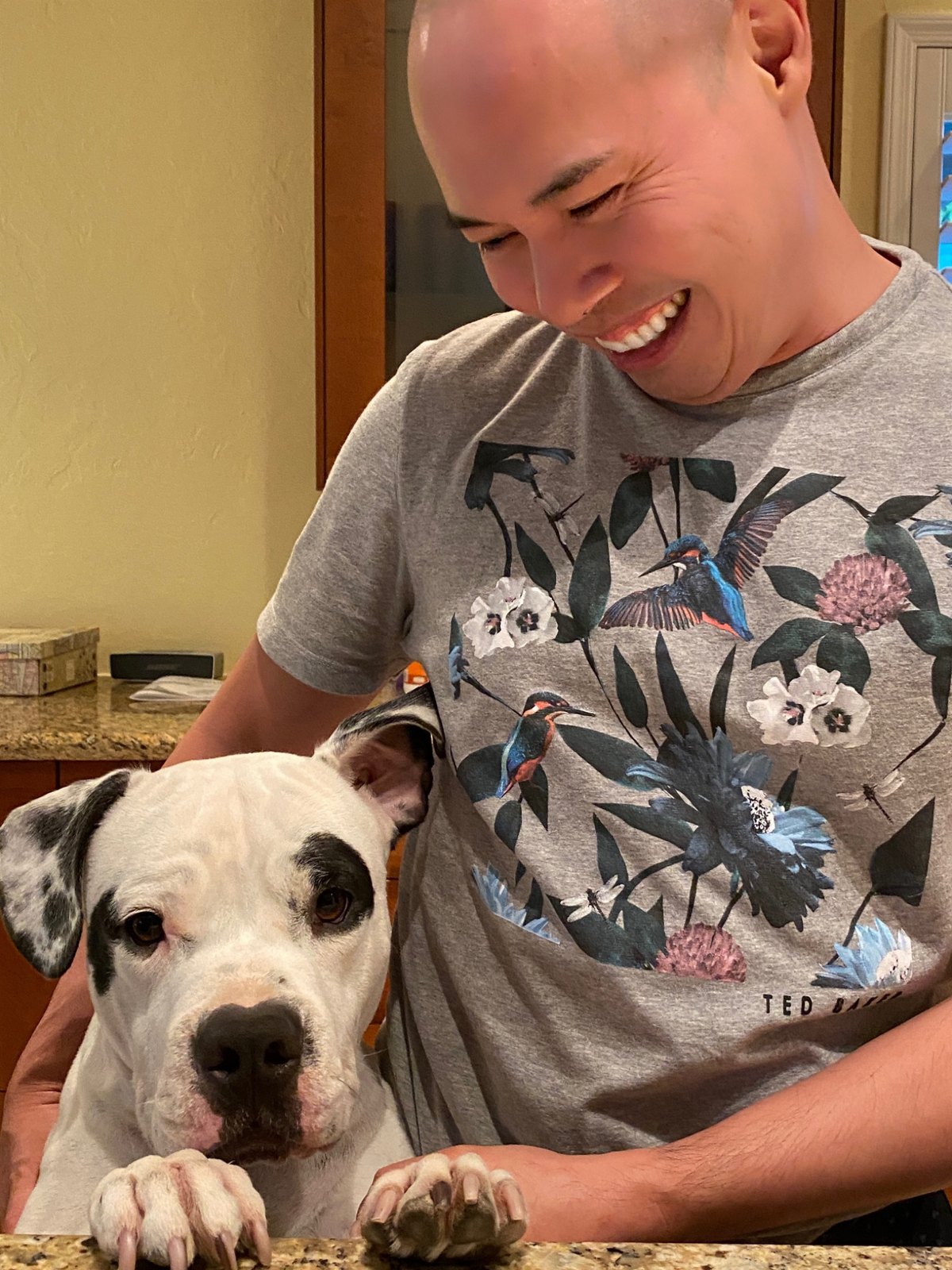 Billy, a white rescue dog, with a Cruz Eberle Foundation supporter